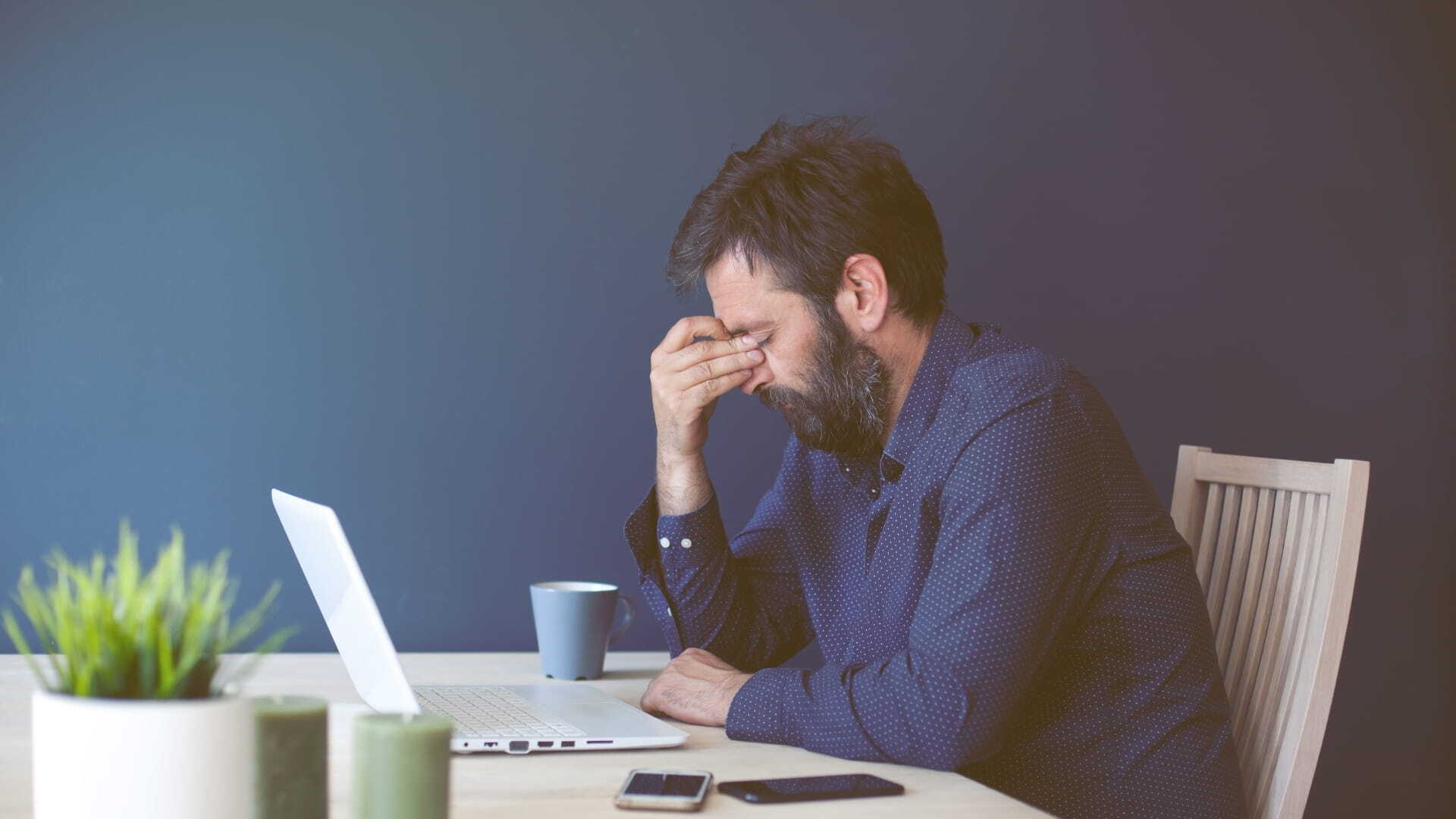 Frustrated person holding their head